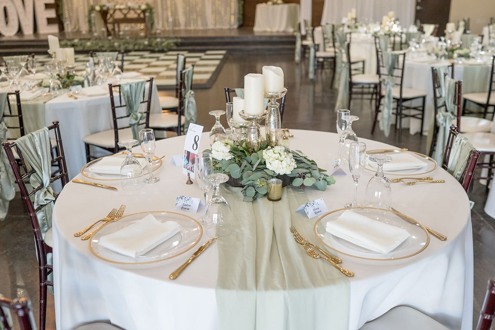 Center piece with green accents and white candles