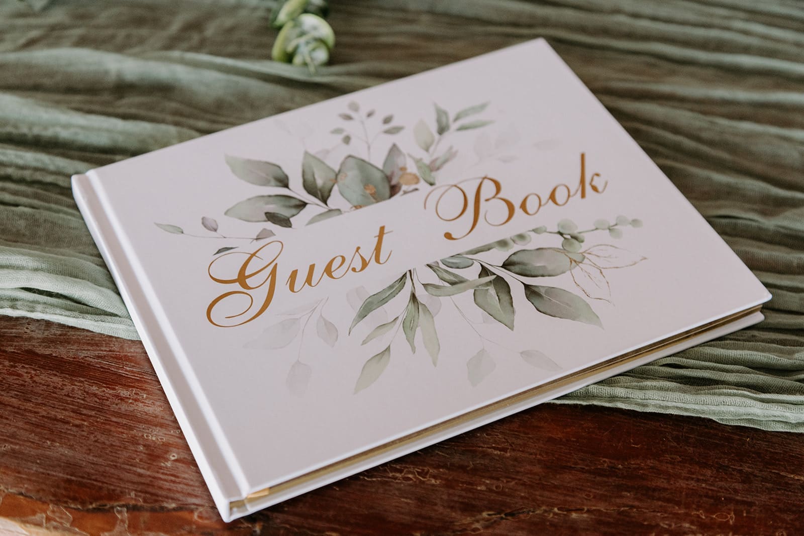 White, green, and gold guest book