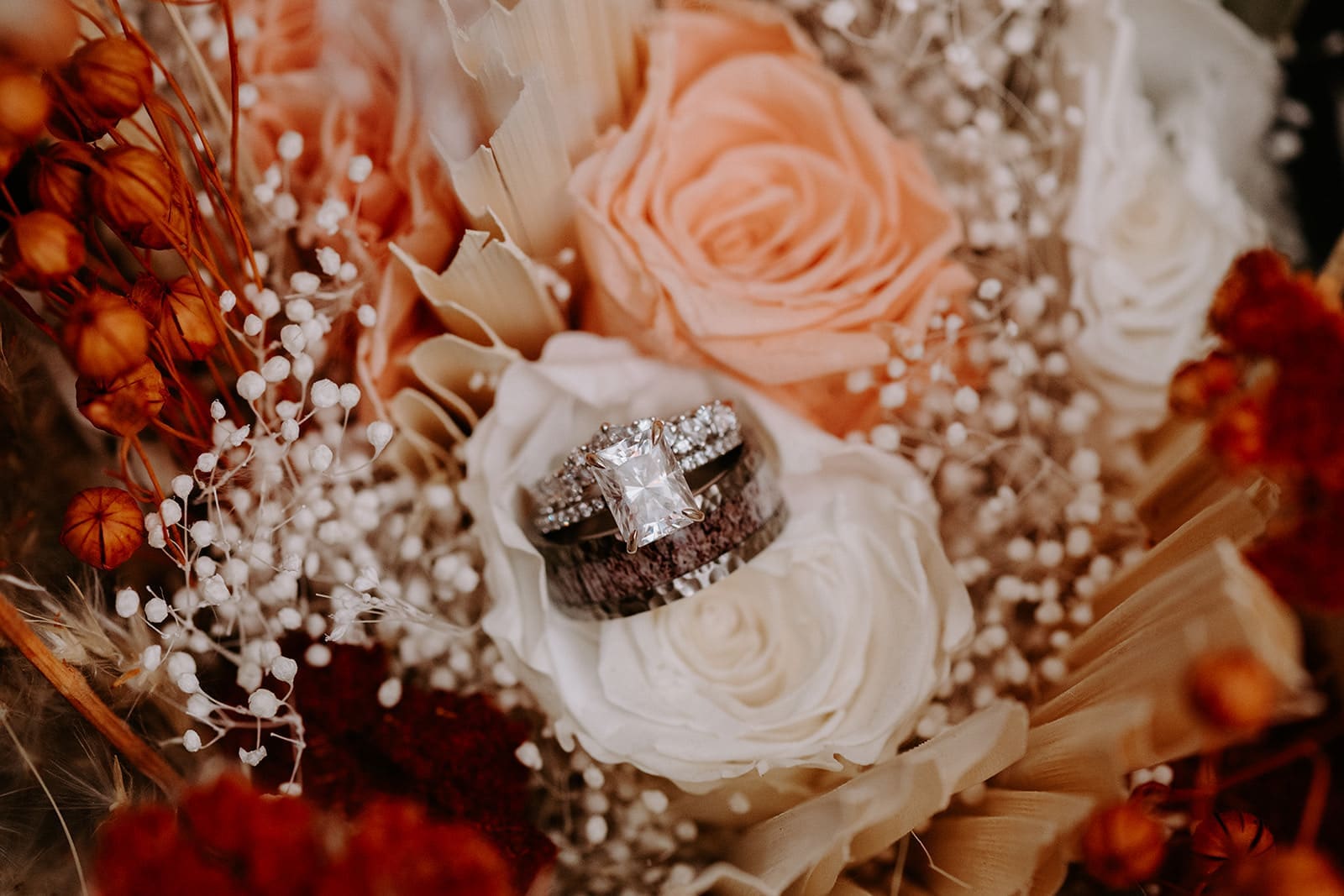 Desert colored florals with wedding rings