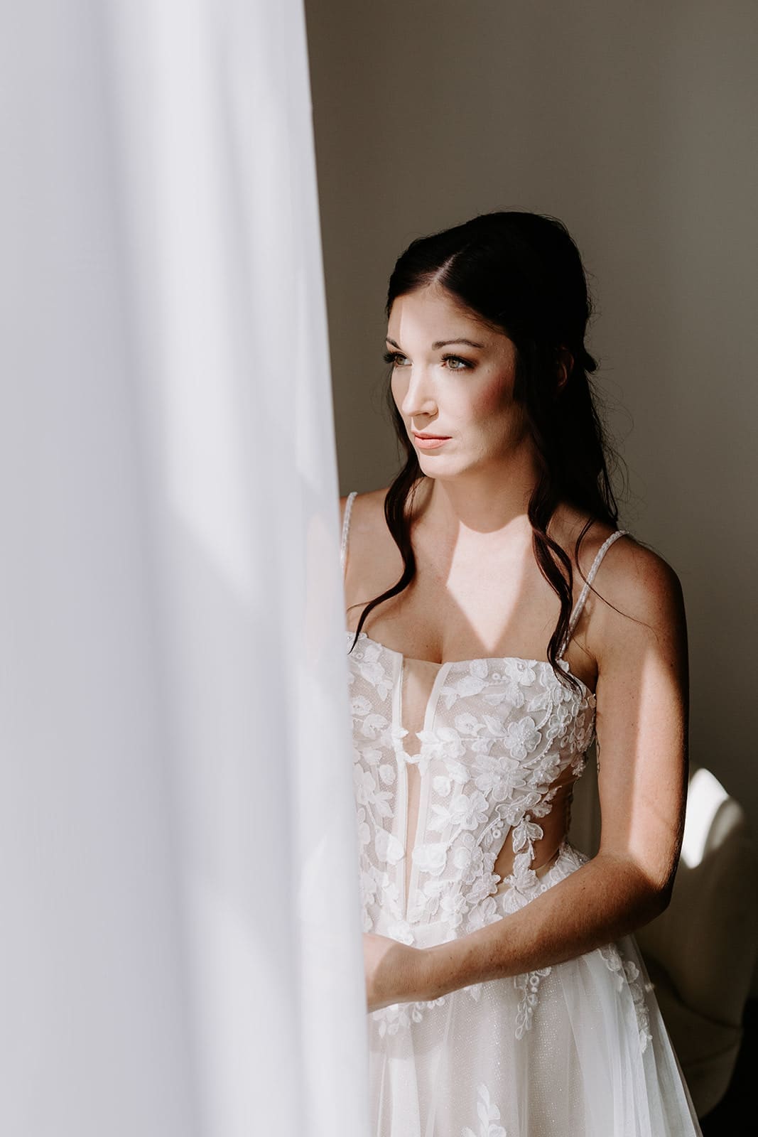 Bride gazing out of window