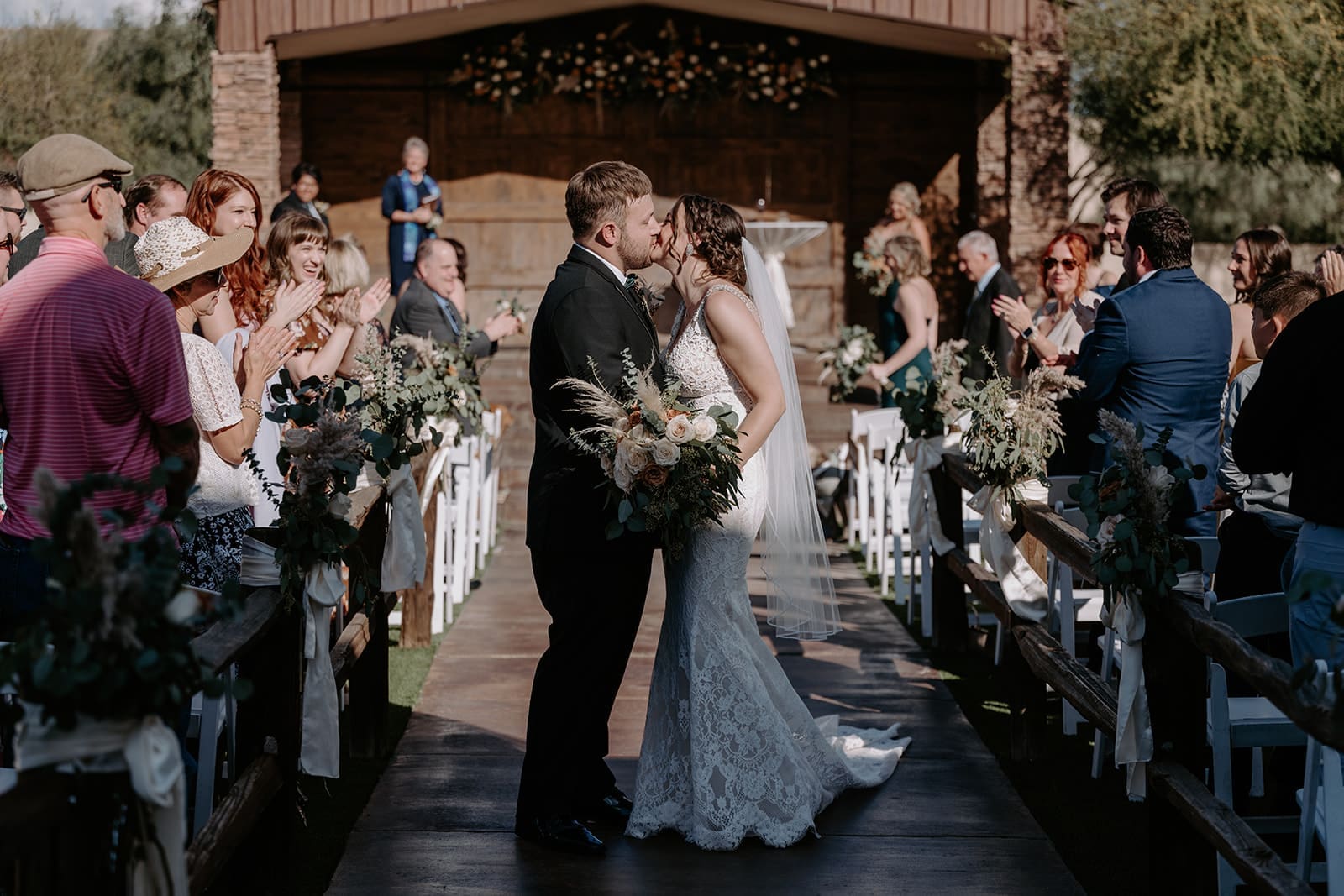 Ceremony kiss with bride and groom
