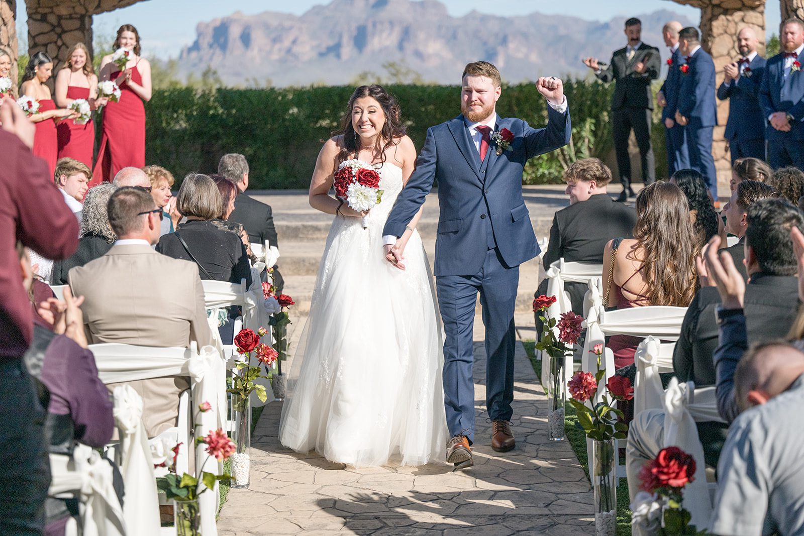 Bride and groom walking down Isle in North Villa at Superstition Manor