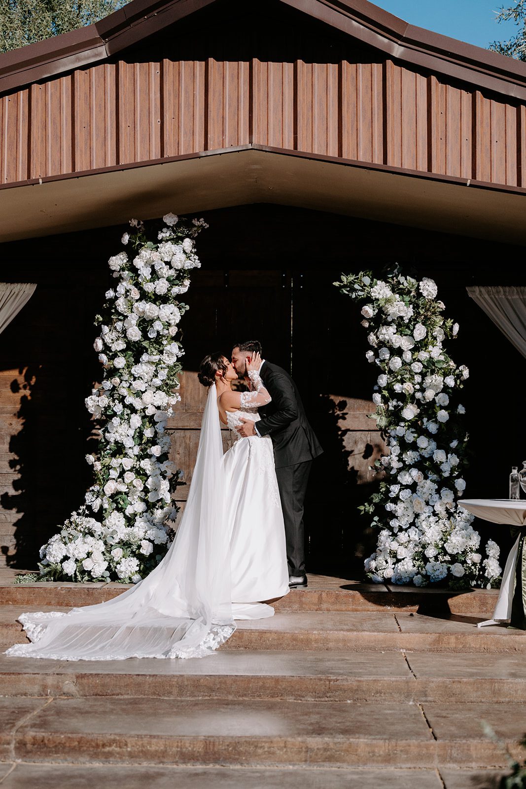 Wedding kiss at superstition manor barn ceremony yard