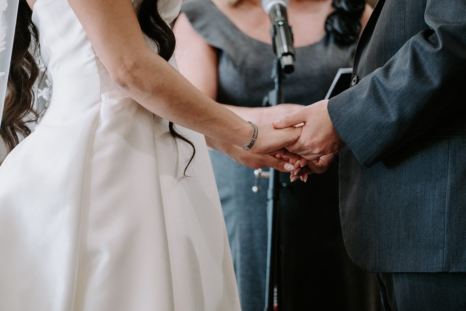 Bride and groom ceremony holding hands 