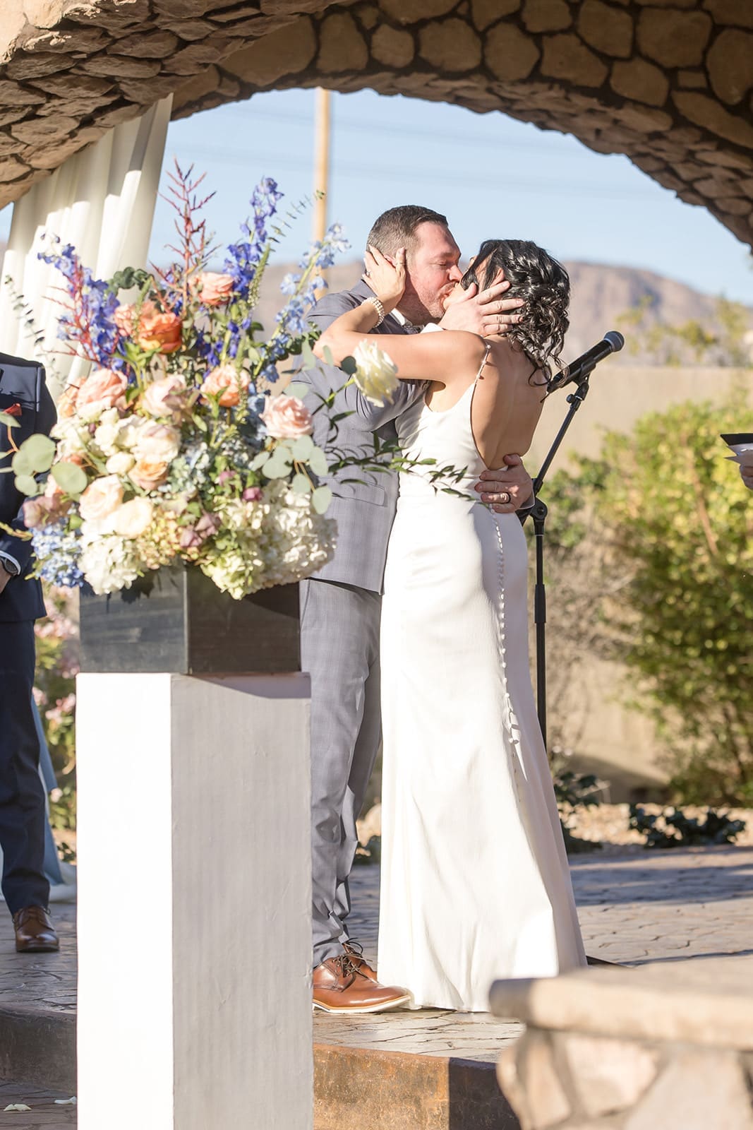 Bride and groom kiss at the end of wedding ceremony