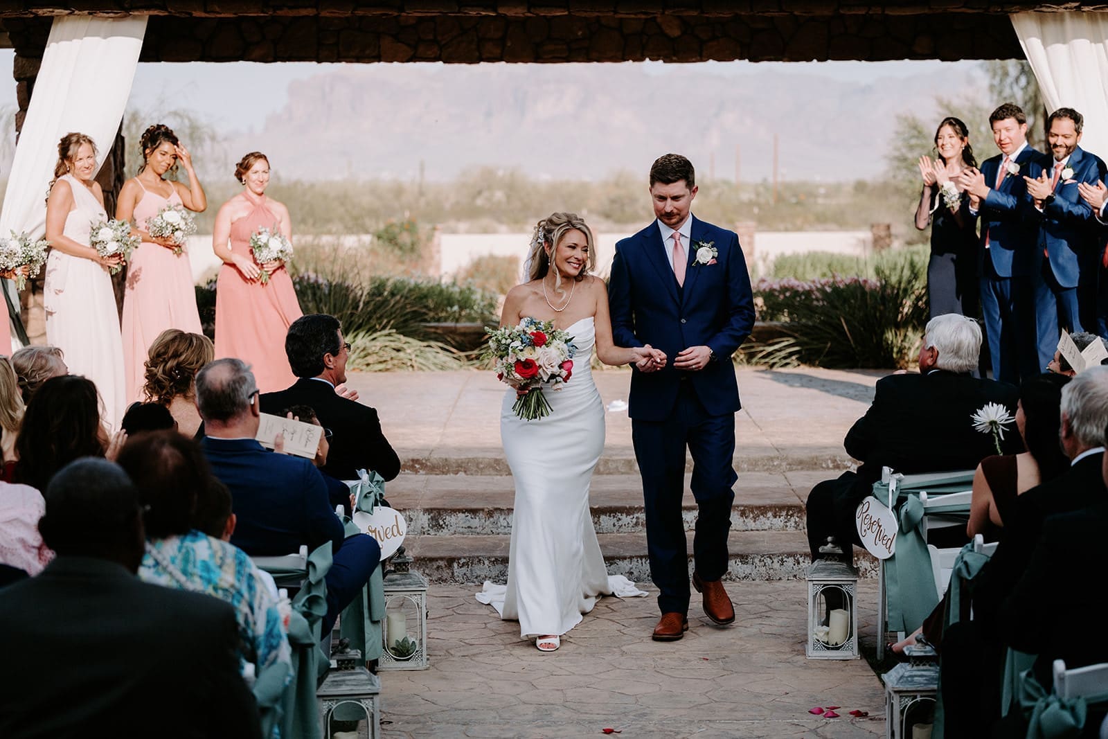 Bride and groom walk the aisle at superstition manor 