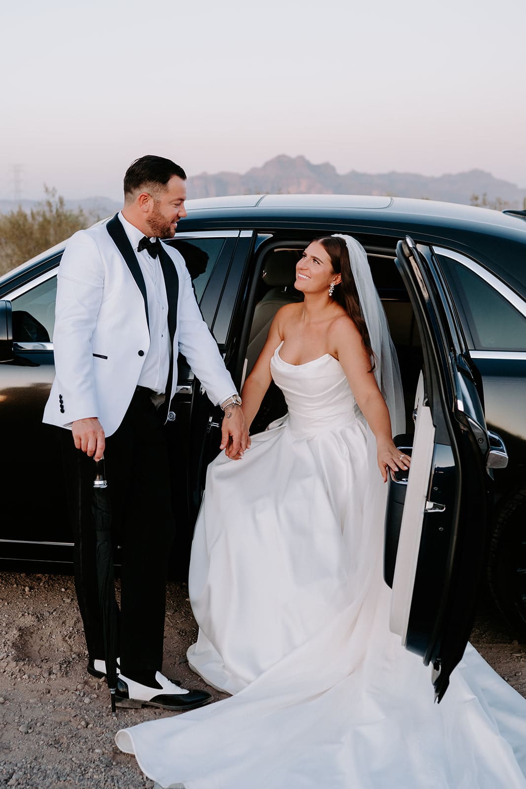 Bride and groom portraits in getaway car