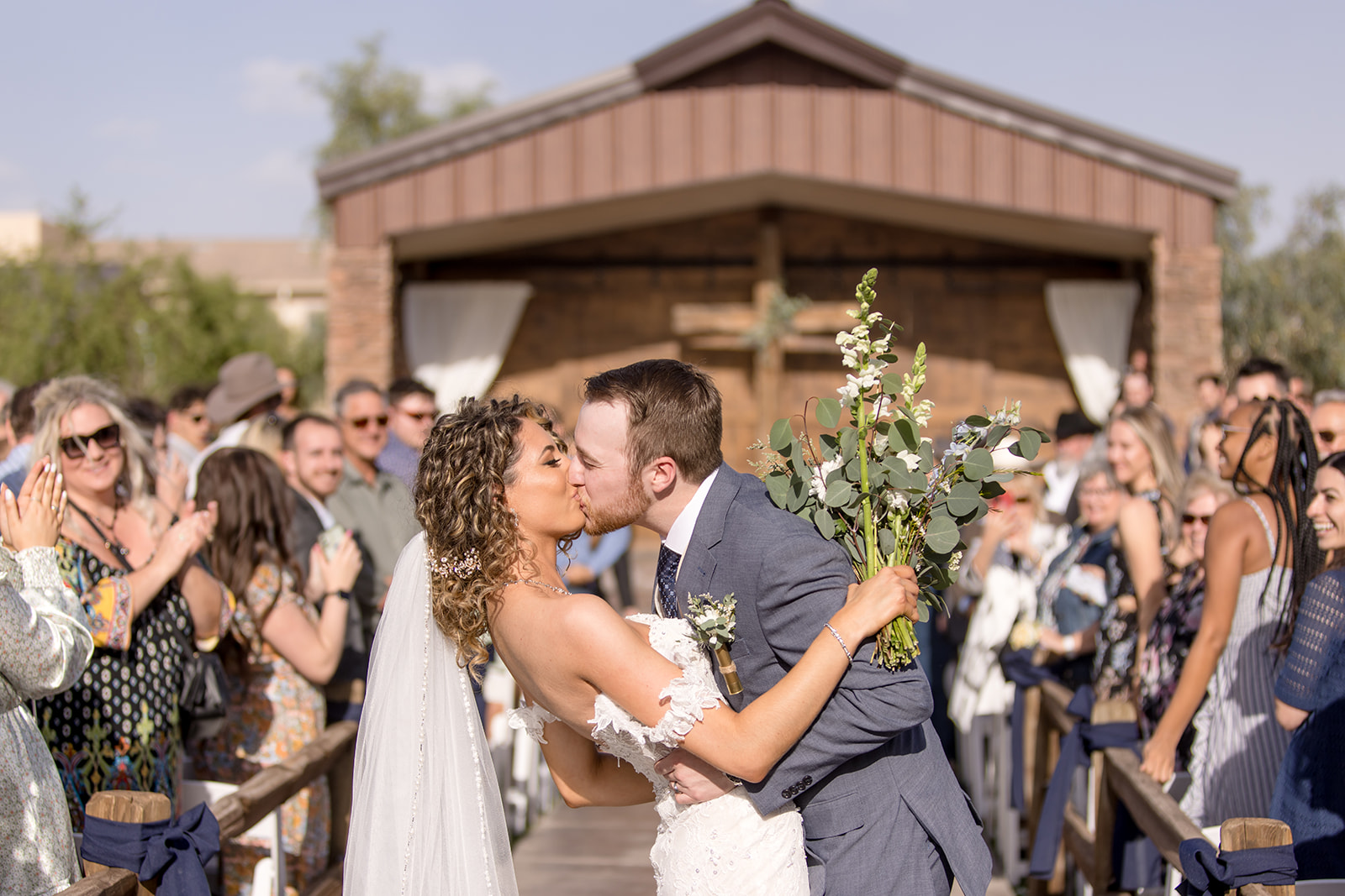 Bride and groom ceremony kiss
